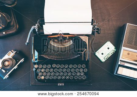 Top View Of Vintage Journalist Workspace With Telephone, Typewriter And Audio Cassette Tape Player