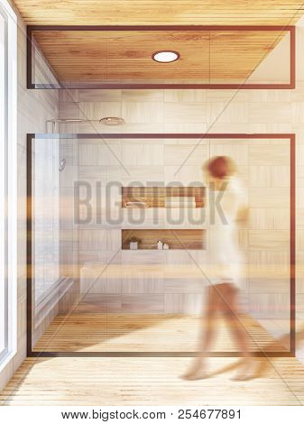 Woman In A Bathroom Interior With White Wooden Walls And Floor, And A Glass Wall Shower Stall. Helve
