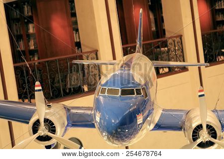 August 14, 2018 In San Francisco, Ca:  Vintage Dc3 Model Aircraft Hanging From The Ceiling With Book