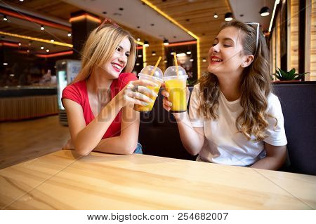 Happy Brightful Positive Moments Of Two Stylish Girls Hugging On Street In City. Closeup Portrait Fu