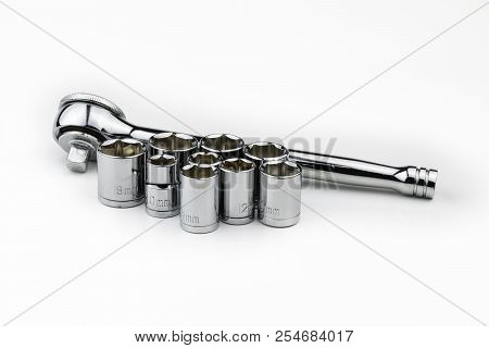 A Shiny, Silver, Chrome Socket Wrench Set With Metric Sockets In Various Sizes In Millimeters On A W