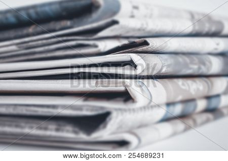 Newspapers Folded And Stacked On The Table. Selective Focus.
