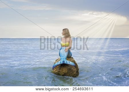 The Real Mermaid Is Reasting On The Sea Shore. Blue Tail. The Body Is Coverd With Scales. Creative