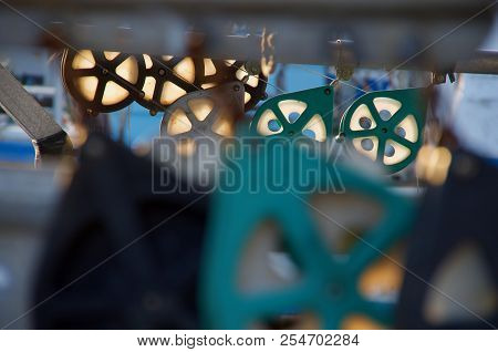 The Late Sun Shines Through The Pulleys On A Commercial Fishing Boat