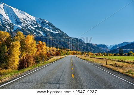 Highway in Colorado Rocky Mountains at autumn, USA. Mount Sopris landscape.