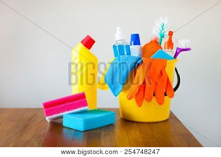 Basket With Cleaning Items On Blurry Background White Citchen. Cleaning Concept.