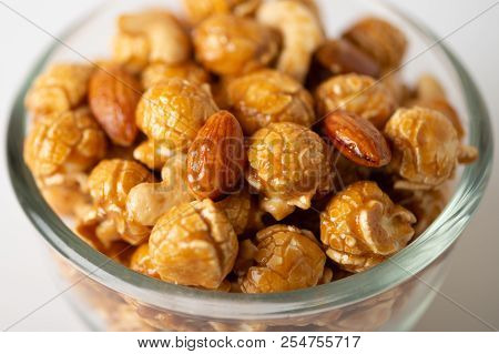 Caramel Popcorn With Cashew Nuts And Almonds In A White Background, Selective Focus.