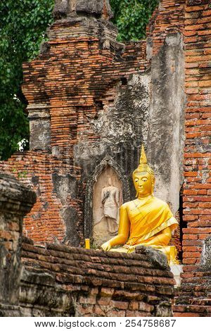Beuatiful Golden Buddha Image In Front Of Old Pagoda In Ancient Ruined Buddhist Temple In Ayutthya, 