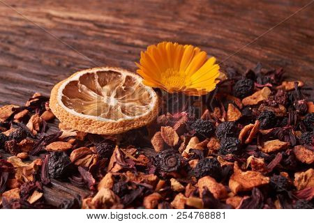 Black Dry Fruit Tea Leaves On Wooden Table. Selective Focus. Space For Text. Copyspace