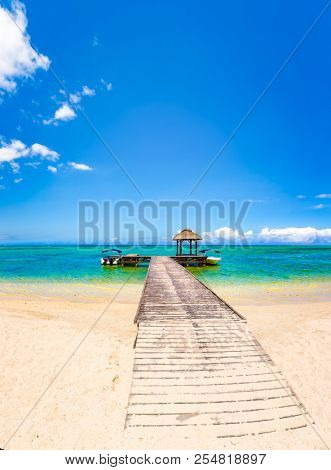 Sandy tropical Wolmar beach at sunny day. Jetty on the foreground. Beautiful landscape. Mauritius