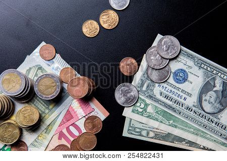 Euros And Usa Dollars Banknotes And Coins With Russian Ruble Coins On Black Background. Concept Of C