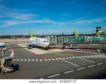 Riga, Latvia - July 8, 2018: Airbaltic airlines airplane boarding at the domestic airport at day time