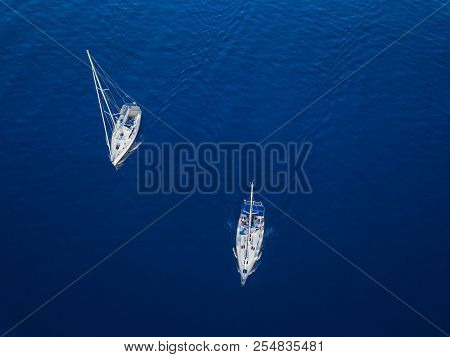 Amasing Aerial View To Two Yachts In Deep Blue Sea. Drone Photography