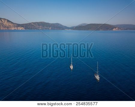 Amasing Aerial View To Two Yachts In Deep Blue Sea. Drone Photography