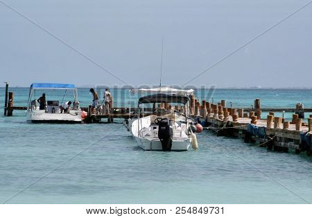 Loading Dive Equipment Onboard A Boat In Cancun