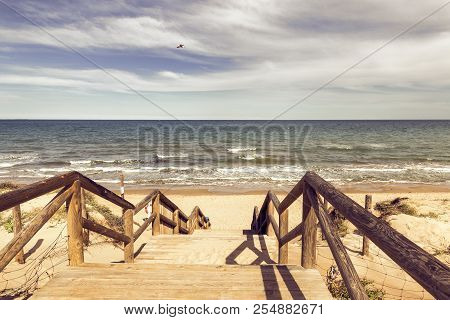 Wooden Stairs On Sand Dunes To Desolate  Guardamar Del Segura Beach. Alicante. Spain