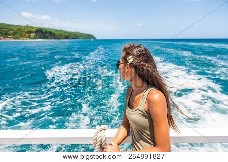 Cruise travel vacation woman relaxing by the water looking at Caribbean sea. St Lucia tourist girl enjoying tropical holidays.