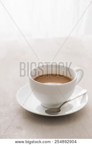 White China Cup Of Tea With Milk On A Plain Background