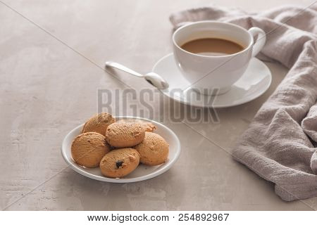 White Cup Of Creamy Coffee With Butter Cookies And Stainless Teaspoon Isolated On White Background, 