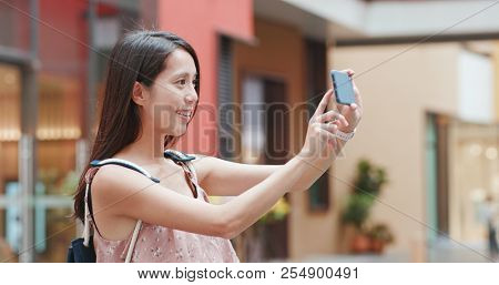 Woman taking photo on cellphone in Shum Yip upperhills