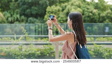Woman taking photo on cellphone in Shum Yip upperhills