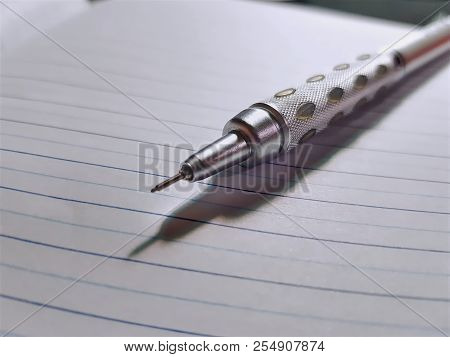 Close-up Metallic Mechanical Pencil On Foolscap Paper
