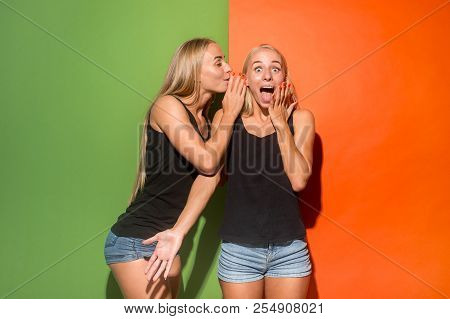 Secret, Gossip Concept. Young Woman Whispering A Secret Behind Her Hand. Business Woman Isolated On 