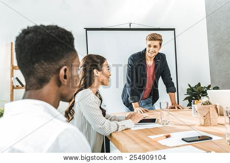 Multiethinc Business Coworkers Having Conversation During Conference In Office