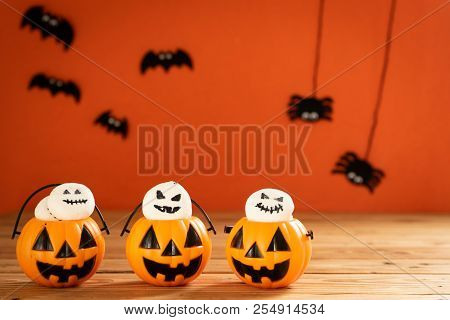 Halloween Crafts, Orange Pumpkin, Ghost And Spide On Wooden Table And Orange Background With Copy Sp