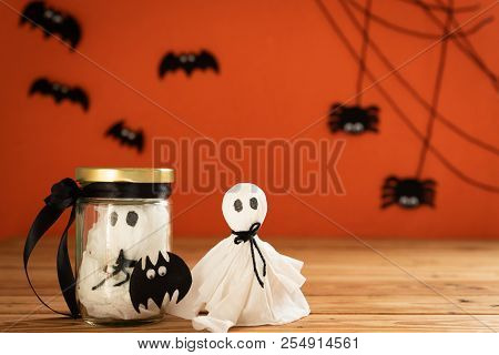 Halloween Crafts, Ghost And Spide On Wooden Table And Orange Background With Copy Space For Text. Ha