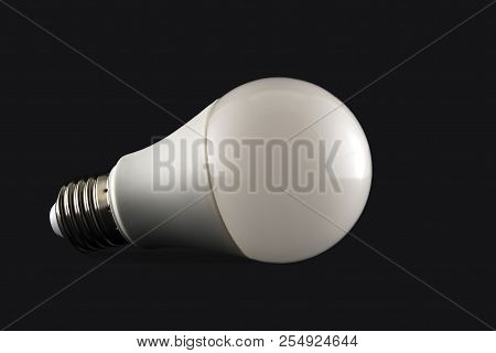 Energy Saving Light Bulb On The Dark Background.