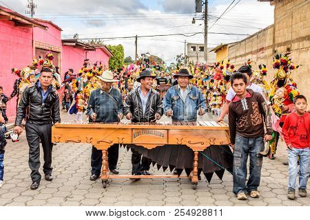 Parramos, Guatemala - December 28, 2016: Marimba Musicians & Traditional Folk Dancers In Masks & Cos
