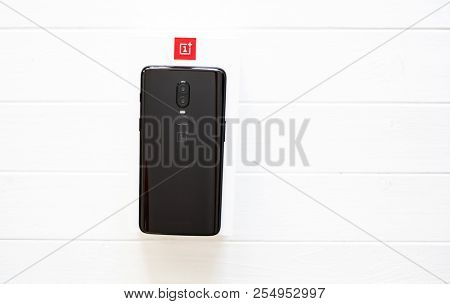 Khakiv, Ukraine - 14 August 2018: Smartphone OnePlus 6 on the white and red box and wooden table