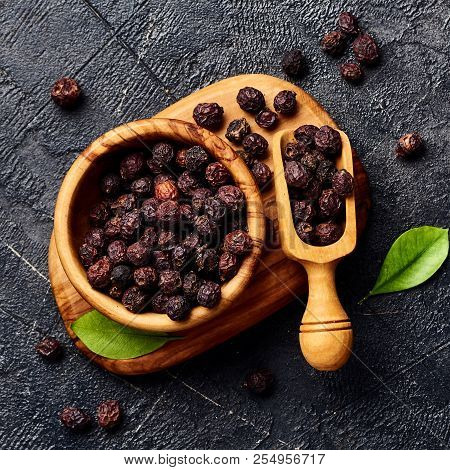 Dried Hawthorn Fruits On Black Background. Top View Of Crataegi Fructus.