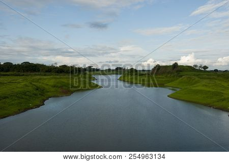 Waterways With Green Fields On Either Side