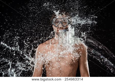 Portrait Of Shirtless Man In Swimming Mask With Snorkel Swilled With Water Splash Isolated On Black