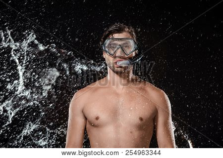 Portrait Of Shirtless Man In Swimming Mask With Snorkel Swilled With Water Isolated On Black