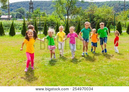 Runnig Children At Summer Camp In The Summer Outdoors