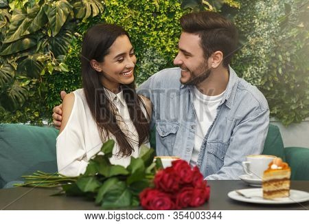 Couple Of Lovers Sitting And Embracing On Romantic Date In Cozy Cafetera Enjoying Coffee. Selective 