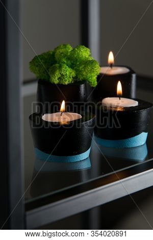 Candles And Moss In Black And Blue Concrete Candle Holders