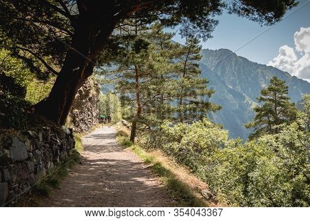 Hikers Climbing A Mountain Path In The Pyrenees In France