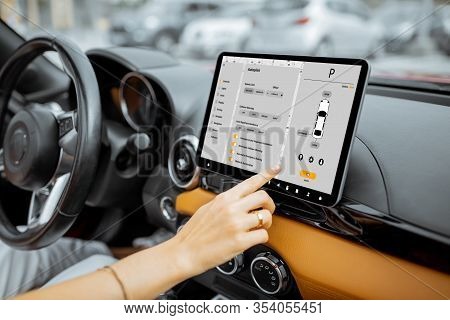 Woman Controlling Car With A Digital Dashboard Switching Autopilot Mode, Close-up On A Touchscreen W