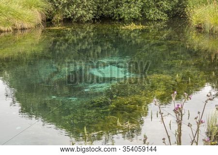 Blue Water Source Coming Up At The Bottom Of A Small Lake