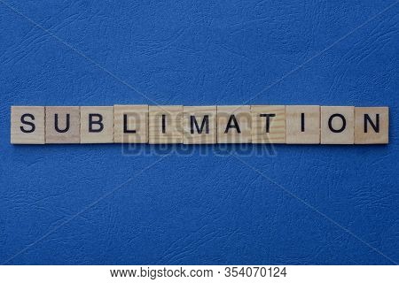 Word Sublimation From Small Gray Wooden Letters Lies On A Blue Background