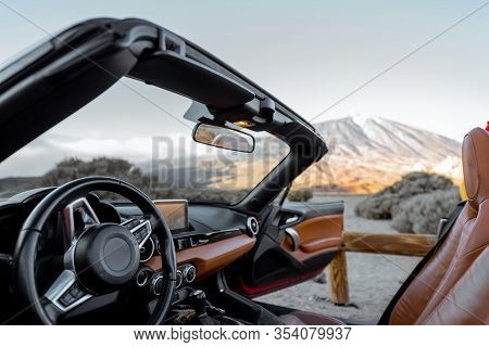 Convertiblle Sports Car On The Roadside With Great View On The Mountains, View From The Car Interior