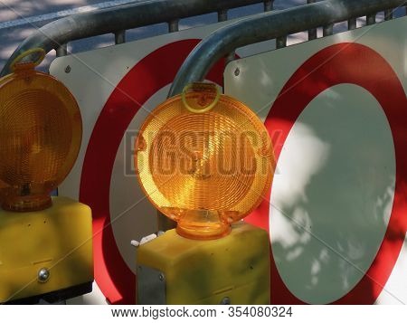 Road Hazard Led Blinker Illuminated By Sunshine And Some Mandatory Roadsigns No Vehicles Behind It O