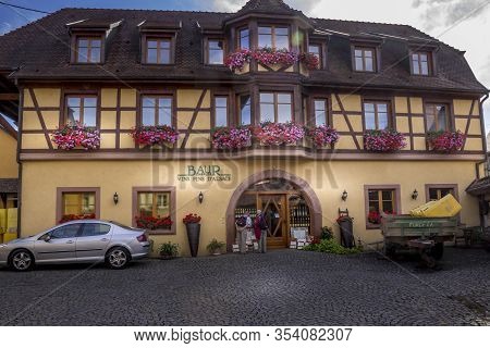 Beautiful View Of Charming Street Scene With Colorful Houses In The Historic Town Of Eguisheim On An