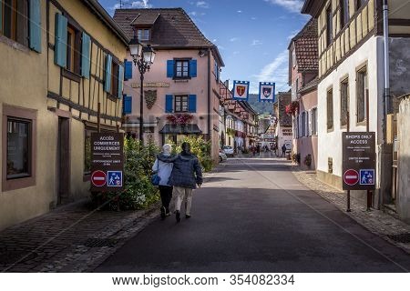 Beautiful View Of Charming Street Scene With Colorful Houses In The Historic Town Of Eguisheim On An