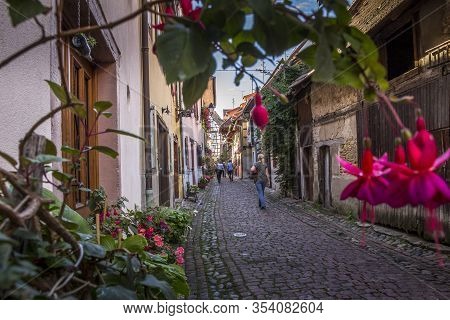 Eguisheim / Alsace, France - 16 Sep. 2015: Beautiful View Of Charming Street Scene With Colorful Hou