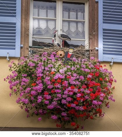 Beautiful View Of Charming Street Scene With Colorful Houses In The Historic Town Of Eguisheim On An